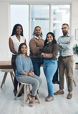 Buy stock photo Full length portrait of a diverse group of businesspeople posing together in the office during the day
