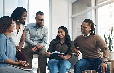 Buy stock photo Cropped shot of a diverse group of businesspeople sitting together and having a discussion in the office