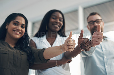 Buy stock photo Cropped portrait of a diverse group of businesspeople standing together and making a thumbs-up gesture in the office