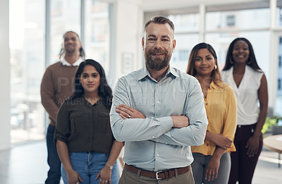 Buy stock photo Cropped portrait of a diverse group of businesspeople standing together in their office during the day