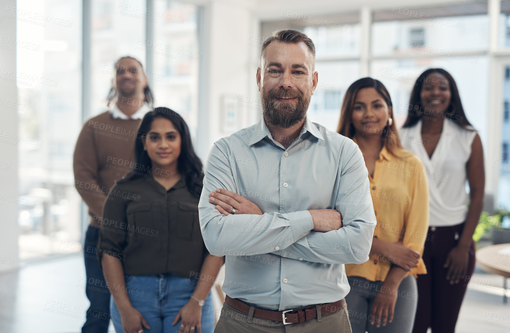 Buy stock photo Cropped portrait of a diverse group of businesspeople standing together in their office during the day