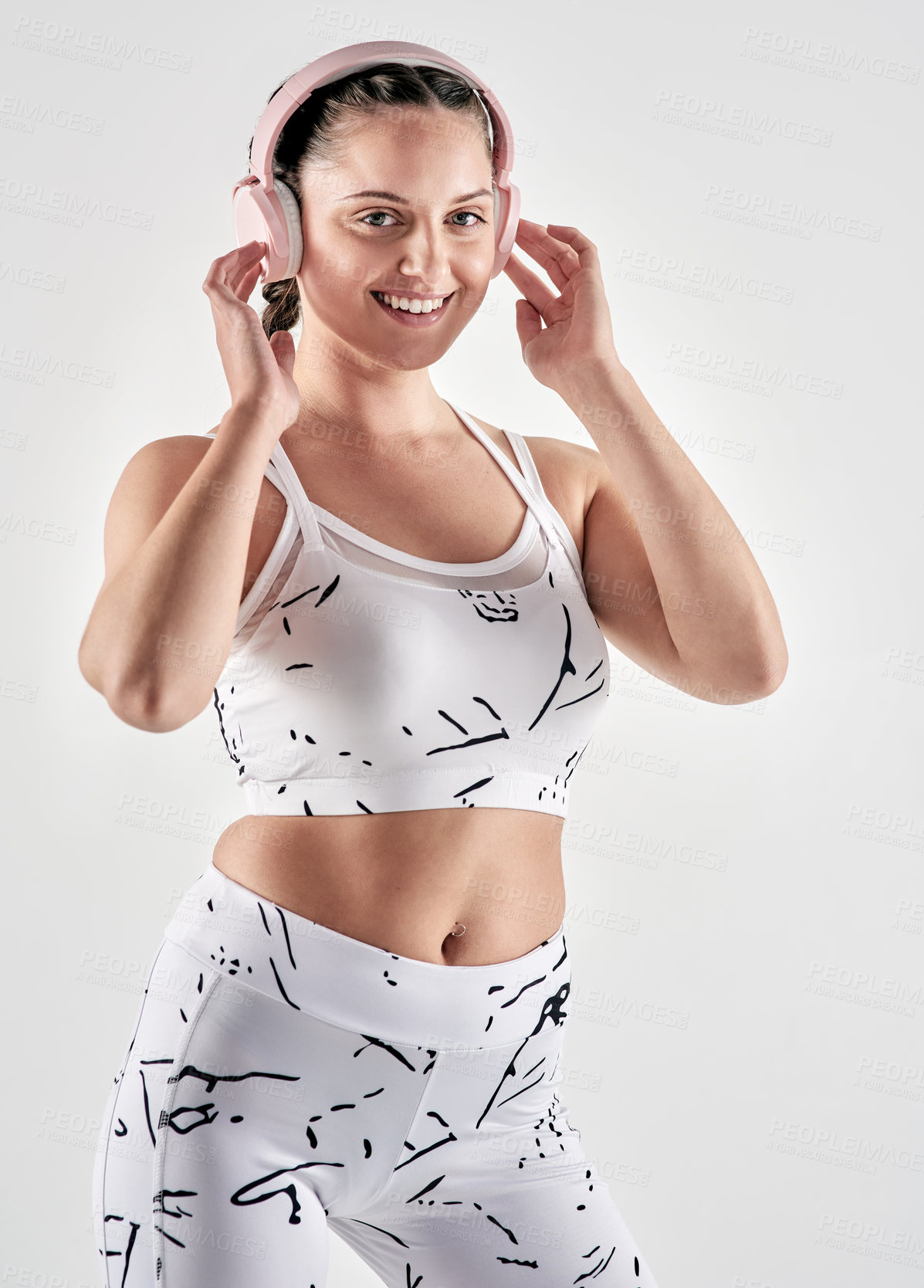 Buy stock photo Smile, athlete and woman with headphones in studio for fitness, exercise and listening to music. Portrait, person or streaming podcast for training, sports motivation and playlist on white background