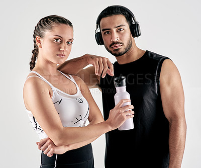 Buy stock photo Studio portrait of a sporty young man and woman posing together against a white background