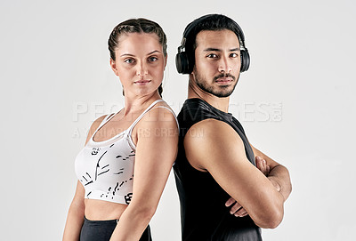 Buy stock photo Studio portrait of a sporty young man and woman posing together against a white background