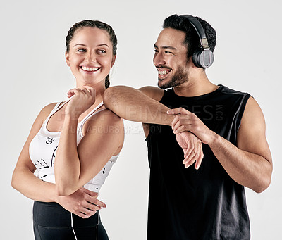 Buy stock photo Studio shot of a sporty young man and woman posing together against a white background