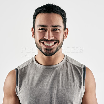 Buy stock photo Studio portrait of a sporty young man posing against a white background