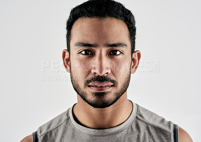 Buy stock photo Studio portrait of a sporty young man posing against a white background