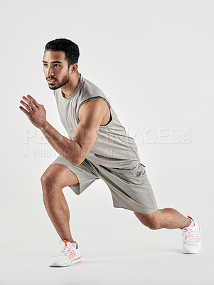 Buy stock photo Studio shot of a sporty young man running against a white background