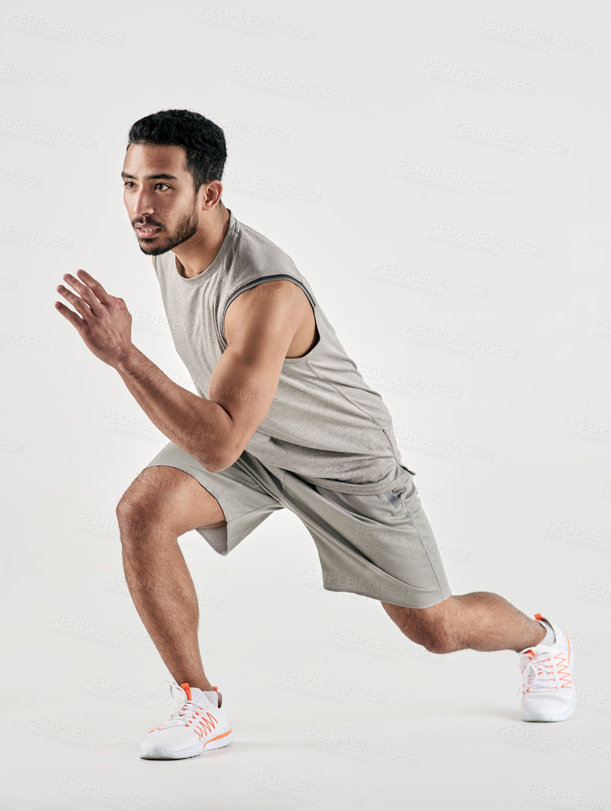 Buy stock photo Studio shot of a sporty young man running against a white background