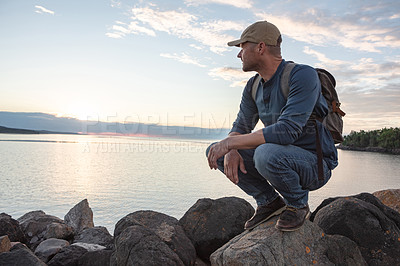 Buy stock photo Shot of a man looking at the ocean while out hiking