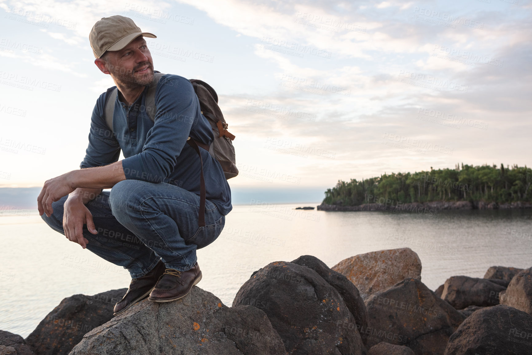 Buy stock photo Hiking, thinking and smile with man in nature for explore, adventure and reflection. Inspiration, eco destination trip and trekking with person outdoor for wellness, peace and ocean view with space