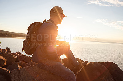 Buy stock photo Shot of a man looking at the ocean while out hiking