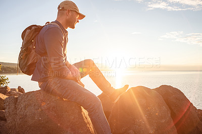 Buy stock photo Shot of a man looking at the ocean while out hiking