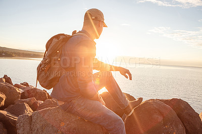 Buy stock photo Shot of a man looking at the ocean while out hiking