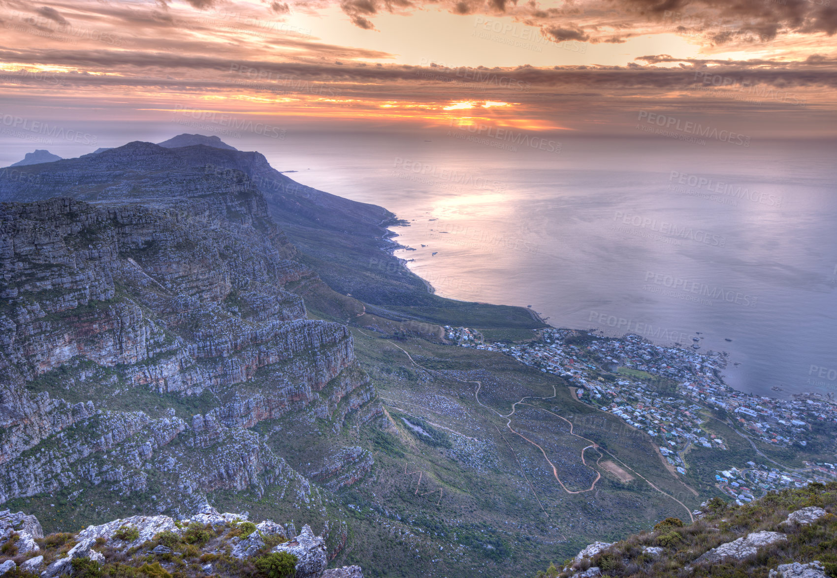 Buy stock photo Beautiful view of an iconic landmark and famous travel or vacation destination to explore nature in South Africa. Aerial view of the sea and Table Mountain on a cloudy day at sunset with copy space.