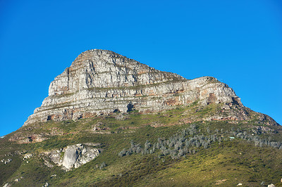 Buy stock photo Beautiful Lions Head mountain on clear blue sky with copy space. Summer landscape of mountains with hills covered in green grass or bushes at a tourism sightseeing location in Cape Town, South Africa