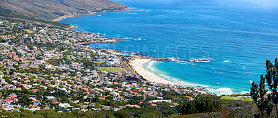 Buy stock photo Beautiful view of a blue calm ocean on the coast of Western Cape, South Africa with views of a city on a sunny day. Soothing, tranquil water in harmony with nature and fresh air along a coastline