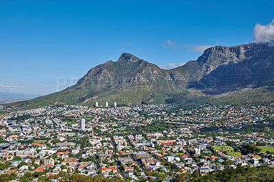 Buy stock photo The landscape of an urban town surrounded by green plants and mountains on a summer day. Scenic view of a holiday destination near nature. Aerial view of the beautiful city of Cape Town, South Africa