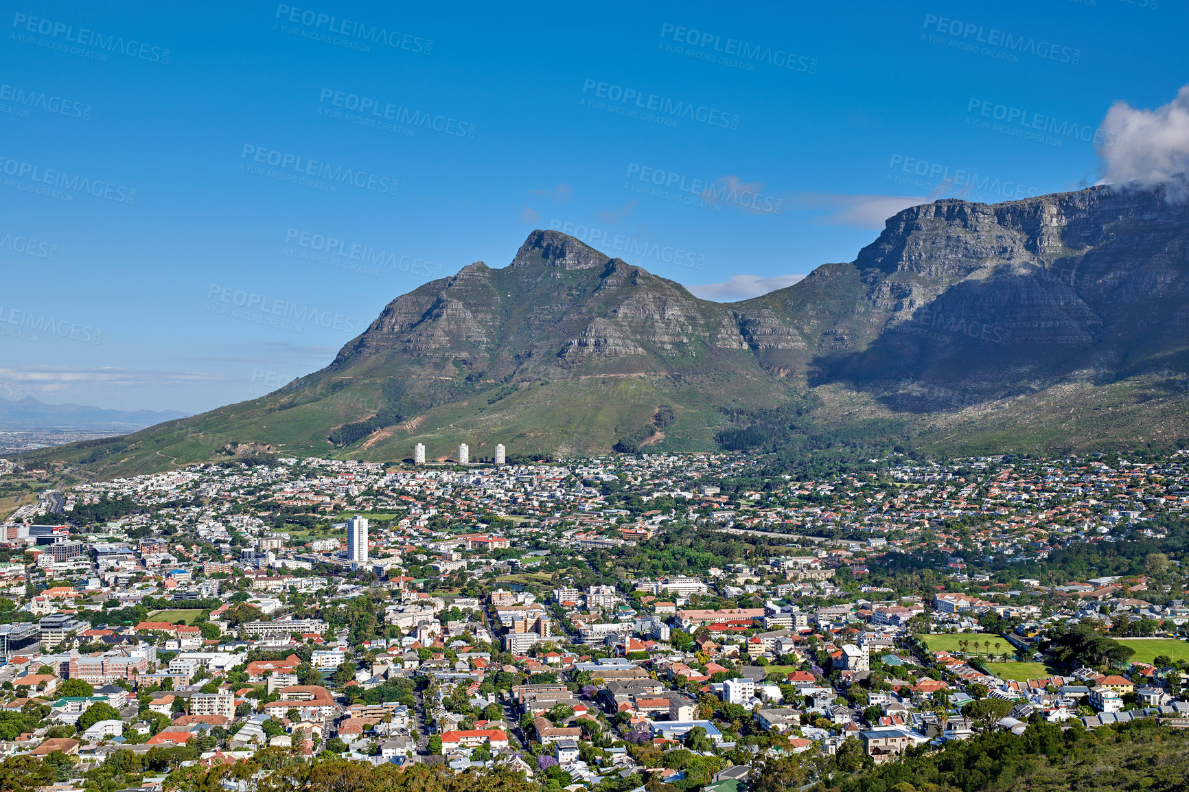 Buy stock photo The landscape of an urban town surrounded by green plants and mountains on a summer day. Scenic view of a holiday destination near nature. Aerial view of the beautiful city of Cape Town, South Africa