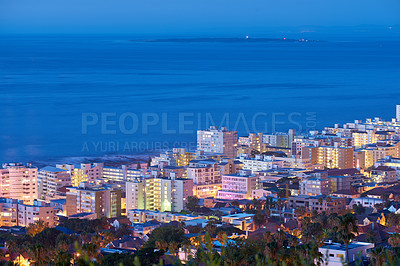 Buy stock photo Beautiful sunset sky over a cityscape view as seen from Signal Hill in Cape Town, South Africa. Scenic panoramic landscape of lights illuminating an urban metropolitan skyline along the sea