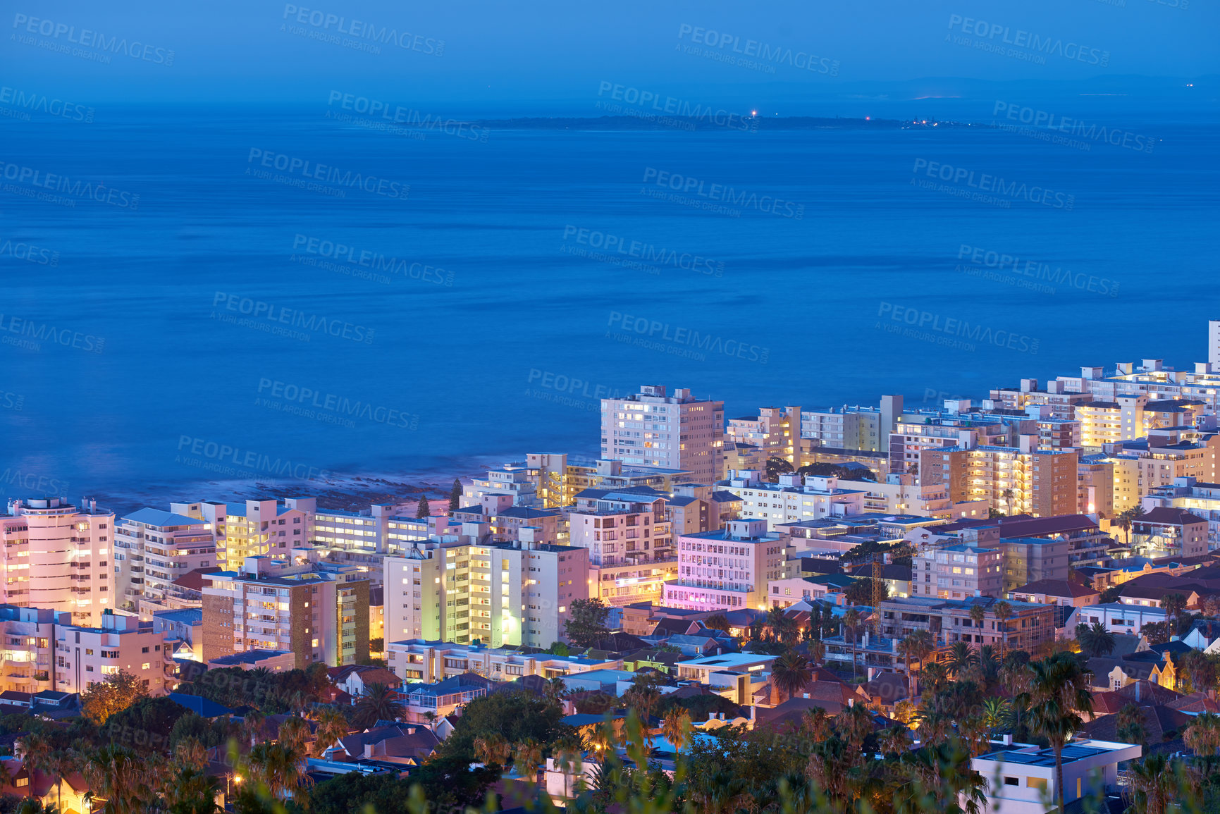 Buy stock photo Beautiful sunset sky over a cityscape view as seen from Signal Hill in Cape Town, South Africa. Scenic panoramic landscape of lights illuminating an urban metropolitan skyline along the sea