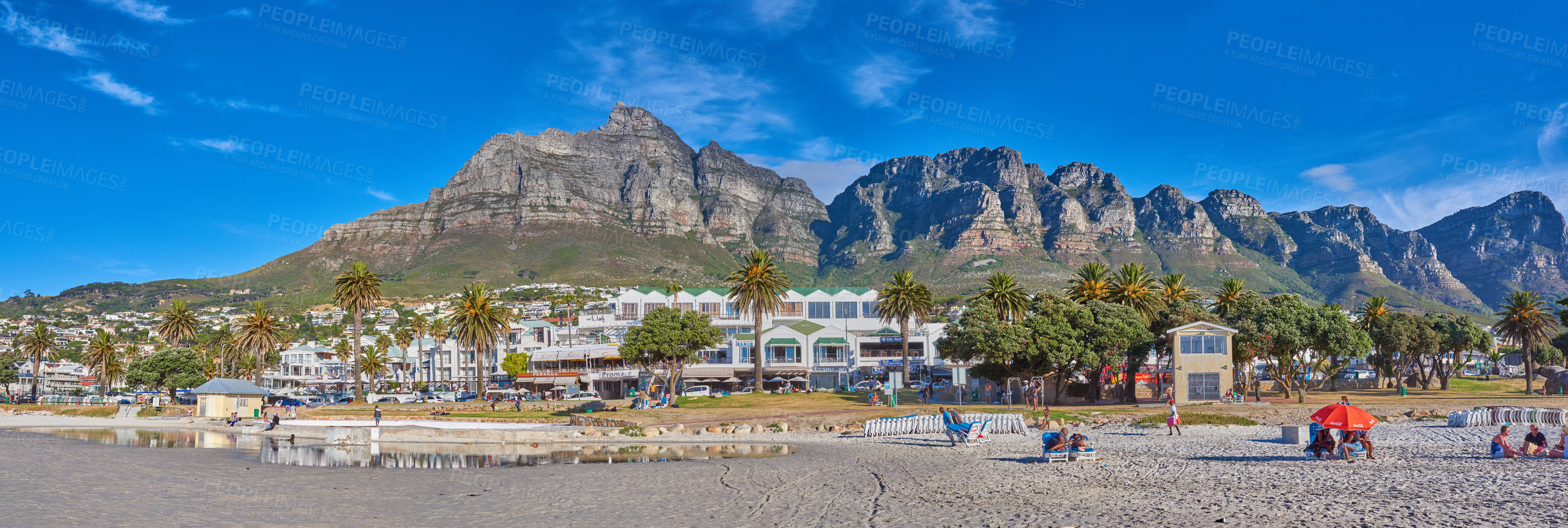 Buy stock photo View of Camps Bay promenade with green palm trees in summer is a great getaway for a vacation. Landscape of Table Mountain on a sunny day in Cape Town, South Africa looking beautiful with copy space.