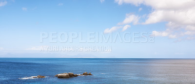 Buy stock photo Beautiful view of a blue calm ocean on the rocky coast of Western Cape, South Africa, against a sunny sky background with copy space. Soothing, tranquil water in harmony with nature and fresh air