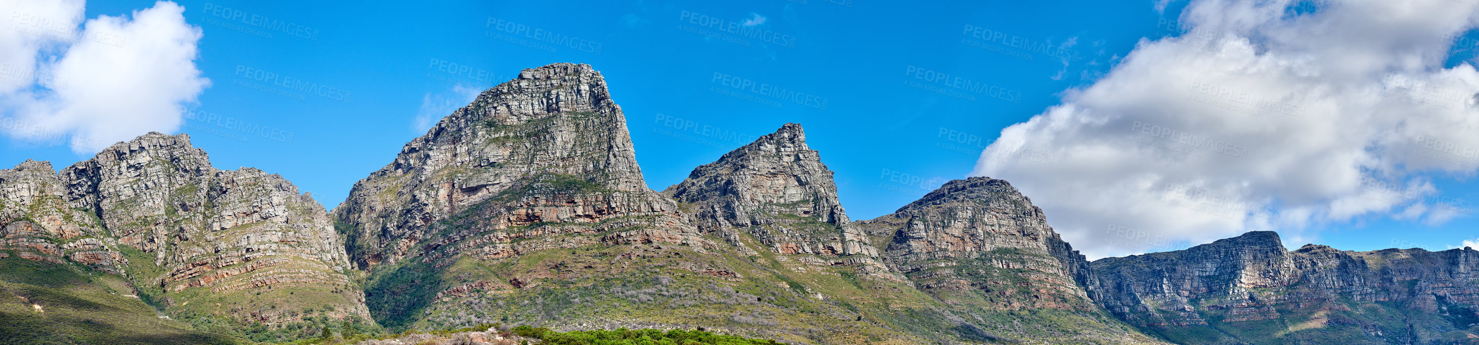 Buy stock photo Twelve Apostles at Table Mountain in Cape Town against a blue sky background from below. Breathtaking view of plants and shrubs growing around a majestic rocky valley and scenic landmark in nature