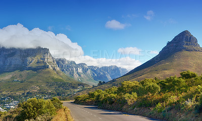 Buy stock photo A road leading to Lions Head, Table mountain and the Twelve Apostles in Cape Town, South Africa. Peaks and lush green landscape on a sunny, peaceful morning with beautiful scenic views and copy space