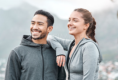 Buy stock photo Shot of a sporty young man and woman exercising outdoors