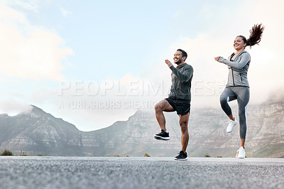 Buy stock photo Shot of a sporty young man and woman exercising together outdoors