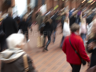 Buy stock photo A group of people commuting through urban roads with blurred motion. A busy crowd of travelers arriving and walking together in a street in the city. Lots of tourists in defocused movement downtown