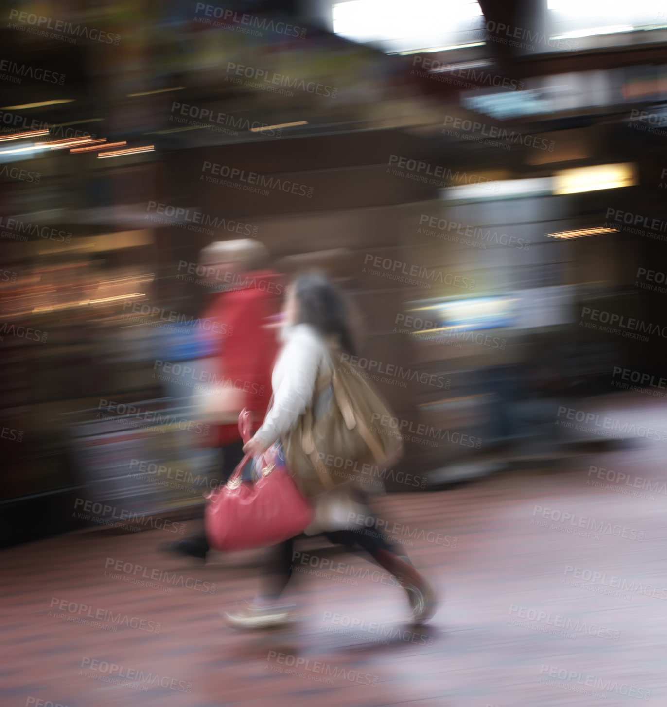 Buy stock photo Blurred motion of a couple commuting through an urban town. Man and woman rushing while walking together in a street in the city. Tourists traveling and exploring abroad in defocused movement