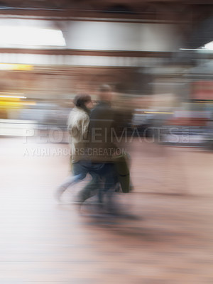 Buy stock photo A busy crowd of travellers arriving and walking together in a street in the city. Group tourists in defocused movement downtown. People travelling in a blurry motion with copy space and bokeh. 