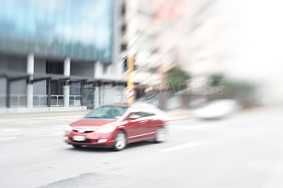 Buy stock photo A lens and motion blurred image of a car in the city