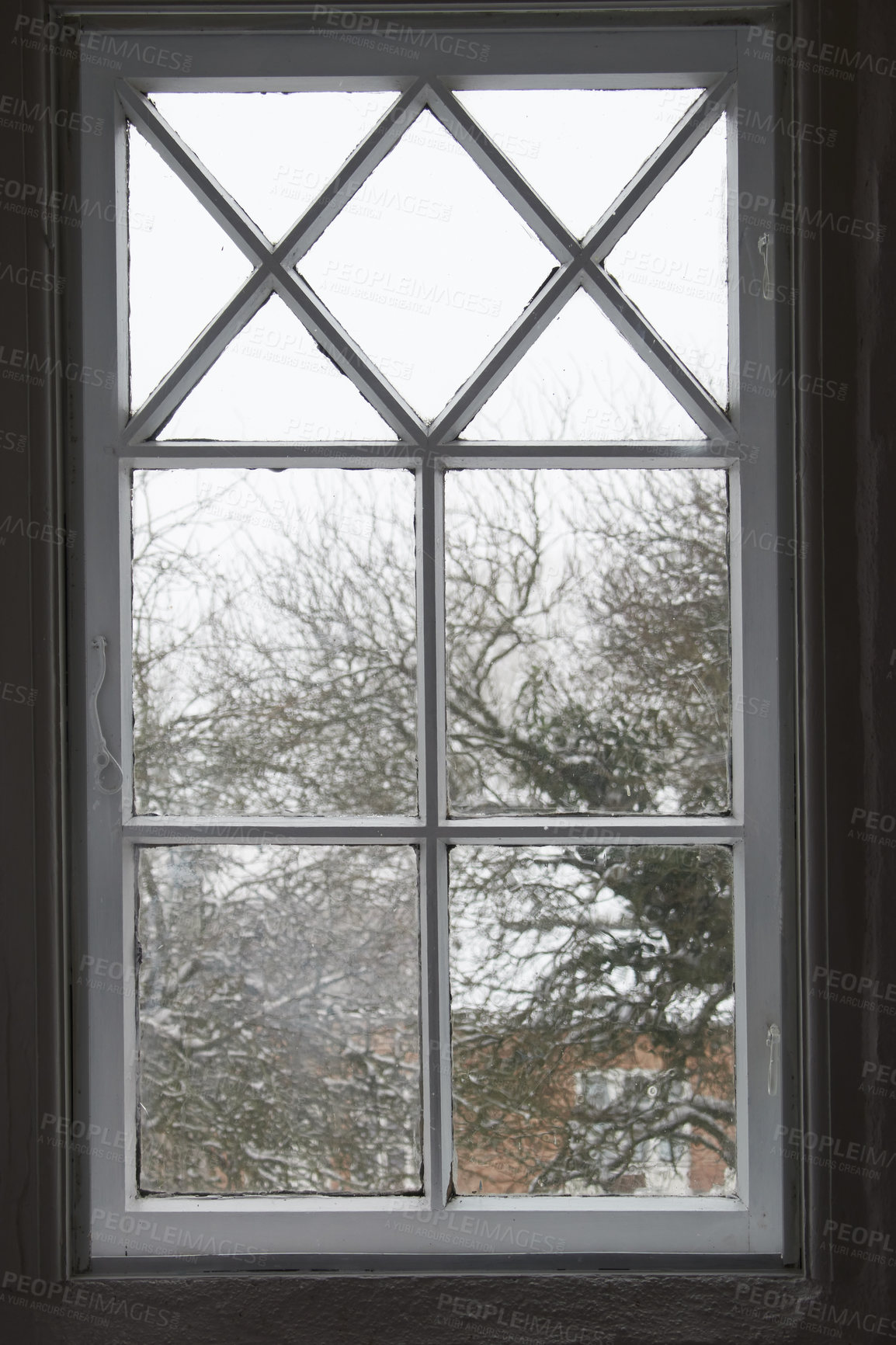 Buy stock photo Closeup of a glass window from inside, looking out on cold weather in the morning. A wooden windowpane with bad insulation, shut and closed with a view of a winter scene with snow, frost and ice. 