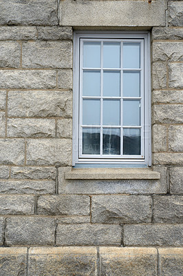 Buy stock photo Shiny window and architecture of a grey brick wall. Exterior texture details of an old rustic residential building or private home with modern wooden windows and windowsill in a town or village 