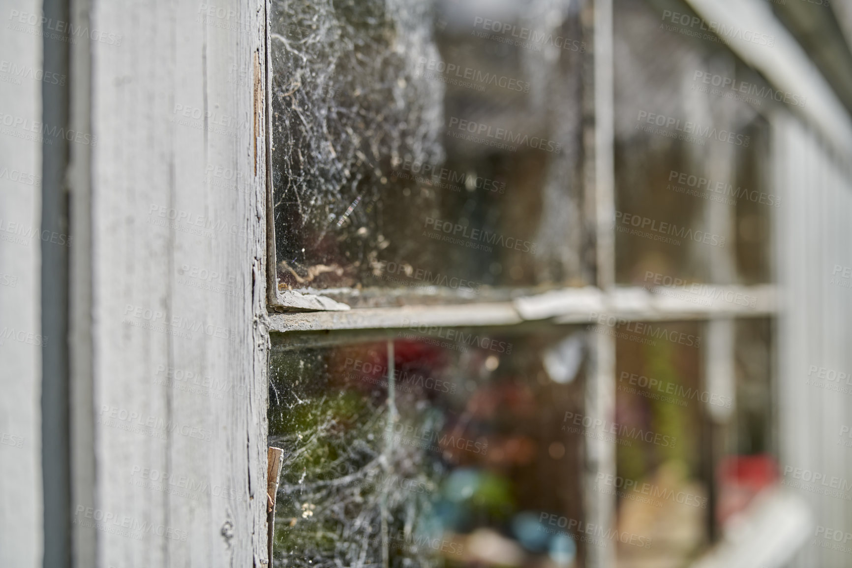 Buy stock photo Abandoned windows being left dirty outside storage house. Damaged frames and structure showing architectural details on the buildings assets. Old window covered with spider webs. 