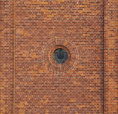 Buy stock photo Wall of a jewish synagogue with round window on an old red brick house outside. Small metal frame on historic temple building with Star of David design and architectural background with copy space