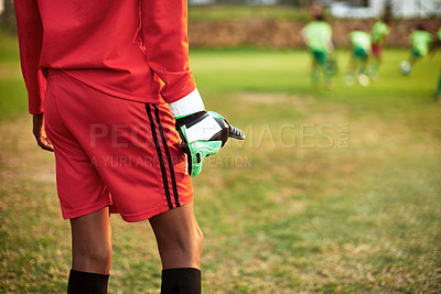 Buy stock photo Closeup shot of a young boy standing as the goalkeeper while playing soccer on a sports field