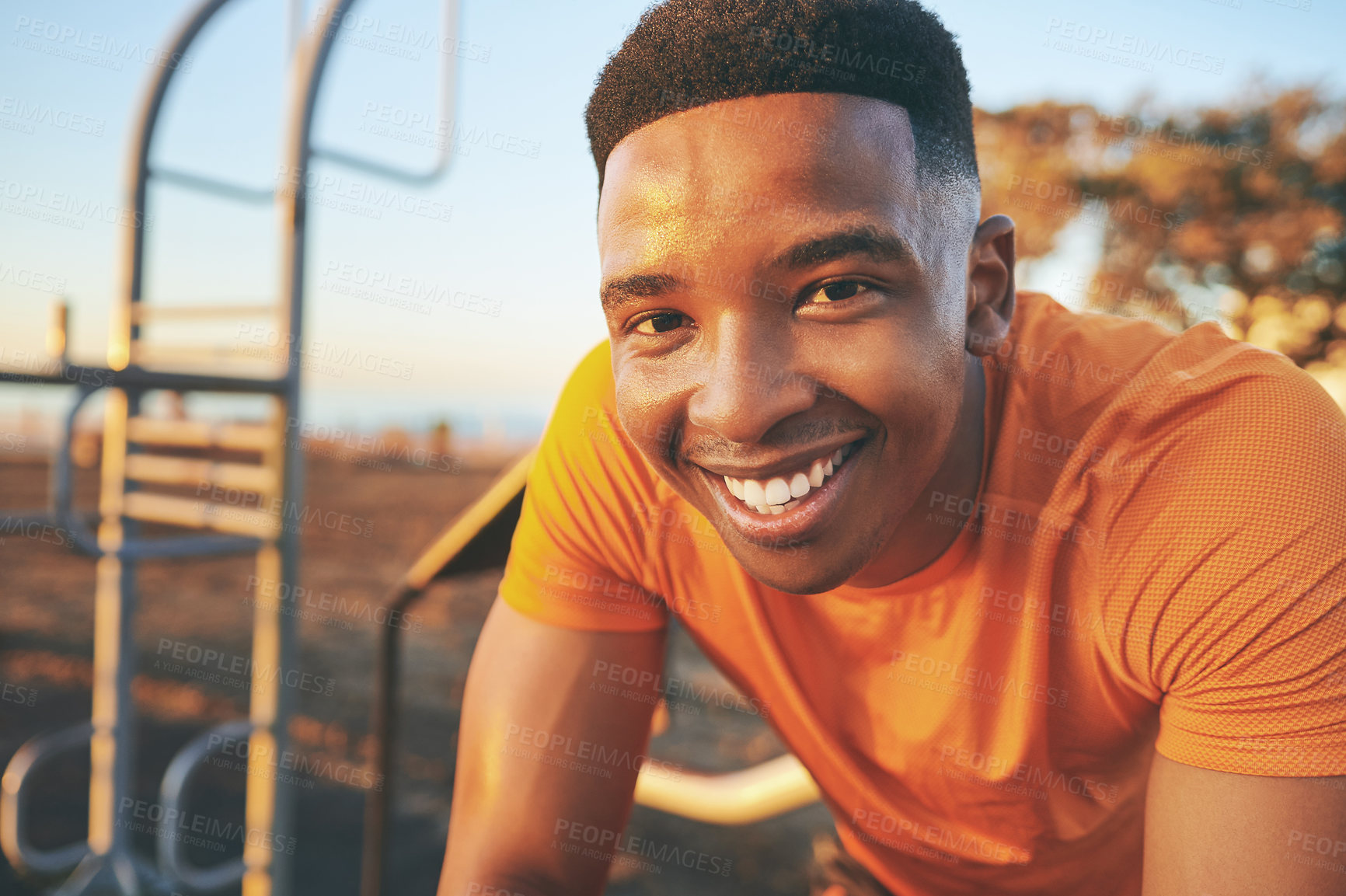 Buy stock photo Cropped shot of a young man looking happy while out at the park for a workout