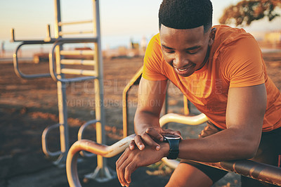 Buy stock photo Shot of a man checking his watch while out for a workout
