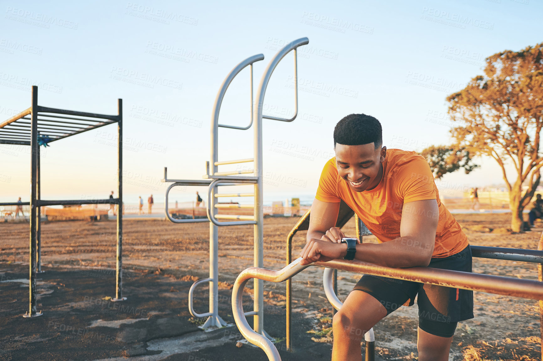 Buy stock photo Shot of a man checking his watch while out for a workout