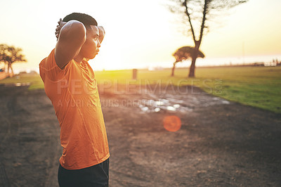 Buy stock photo Shot of a man checking his cellphone while out for a workout