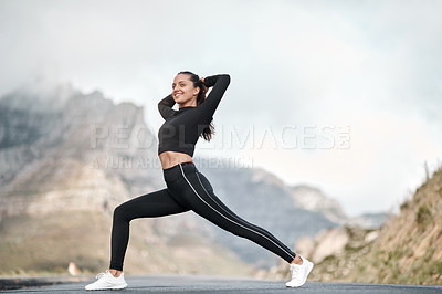 Buy stock photo Full length shot of an attractive young woman stretching before exercising outdoors alone