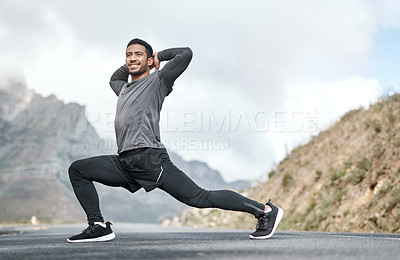 Buy stock photo Full length shot of a handsome young man stretching before exercising outdoors alone