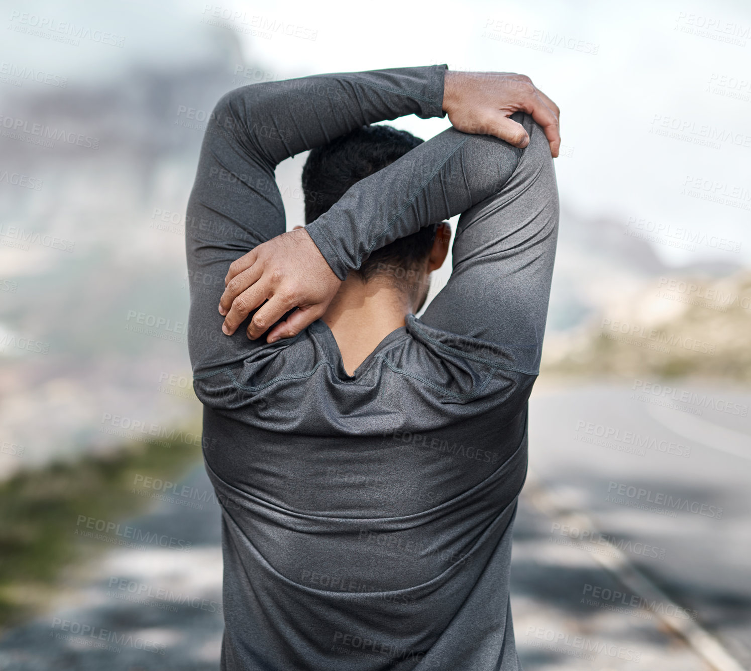 Buy stock photo Cropped shot of an unrecognizable man stretching before exercising outdoors alone