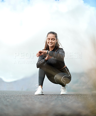 Buy stock photo Full length shot of an attractive young woman preparing herself for a run outdoors alone