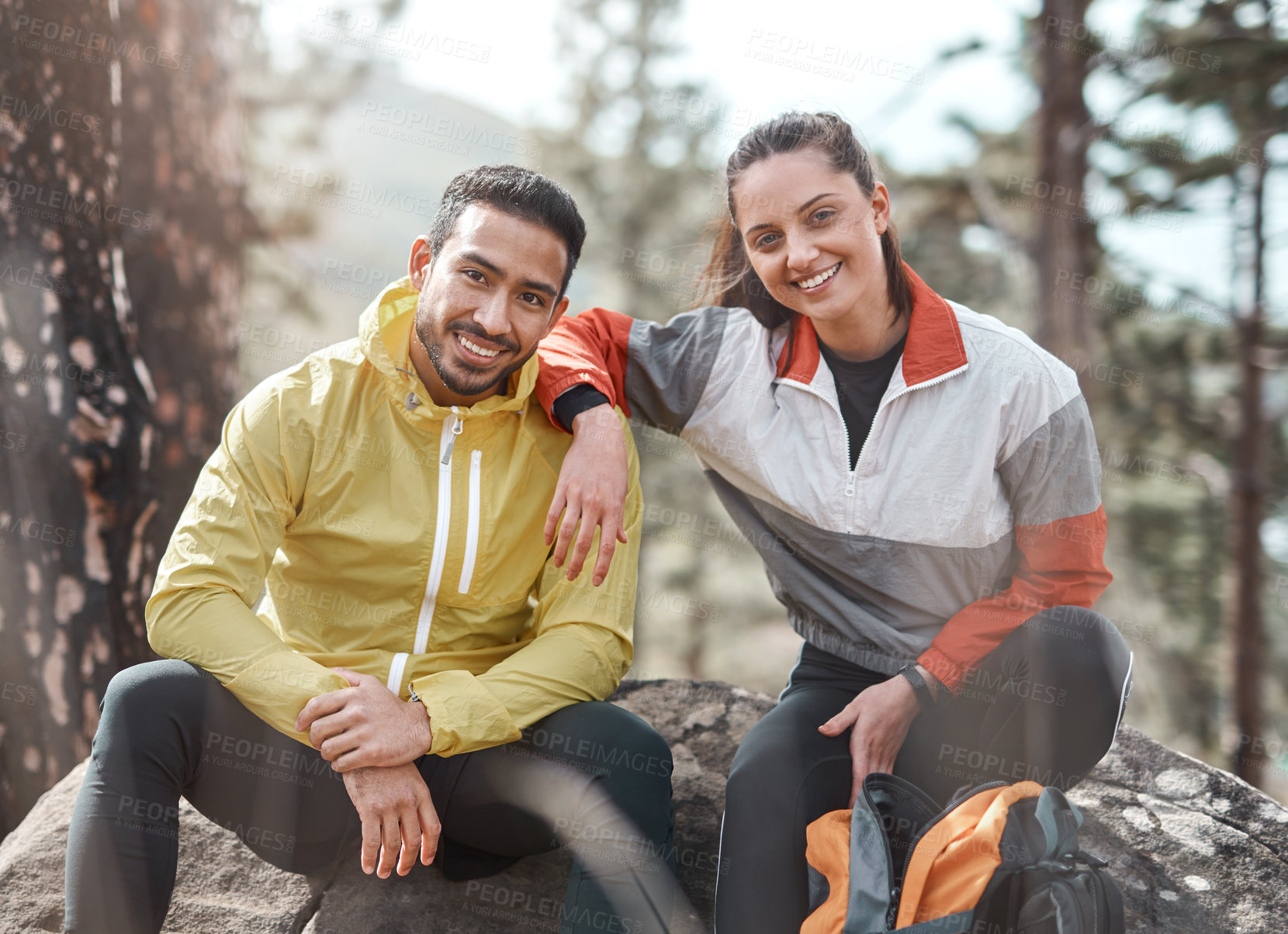 Buy stock photo Cropped portrait of two young athletes sitting together after a morning run through the woods