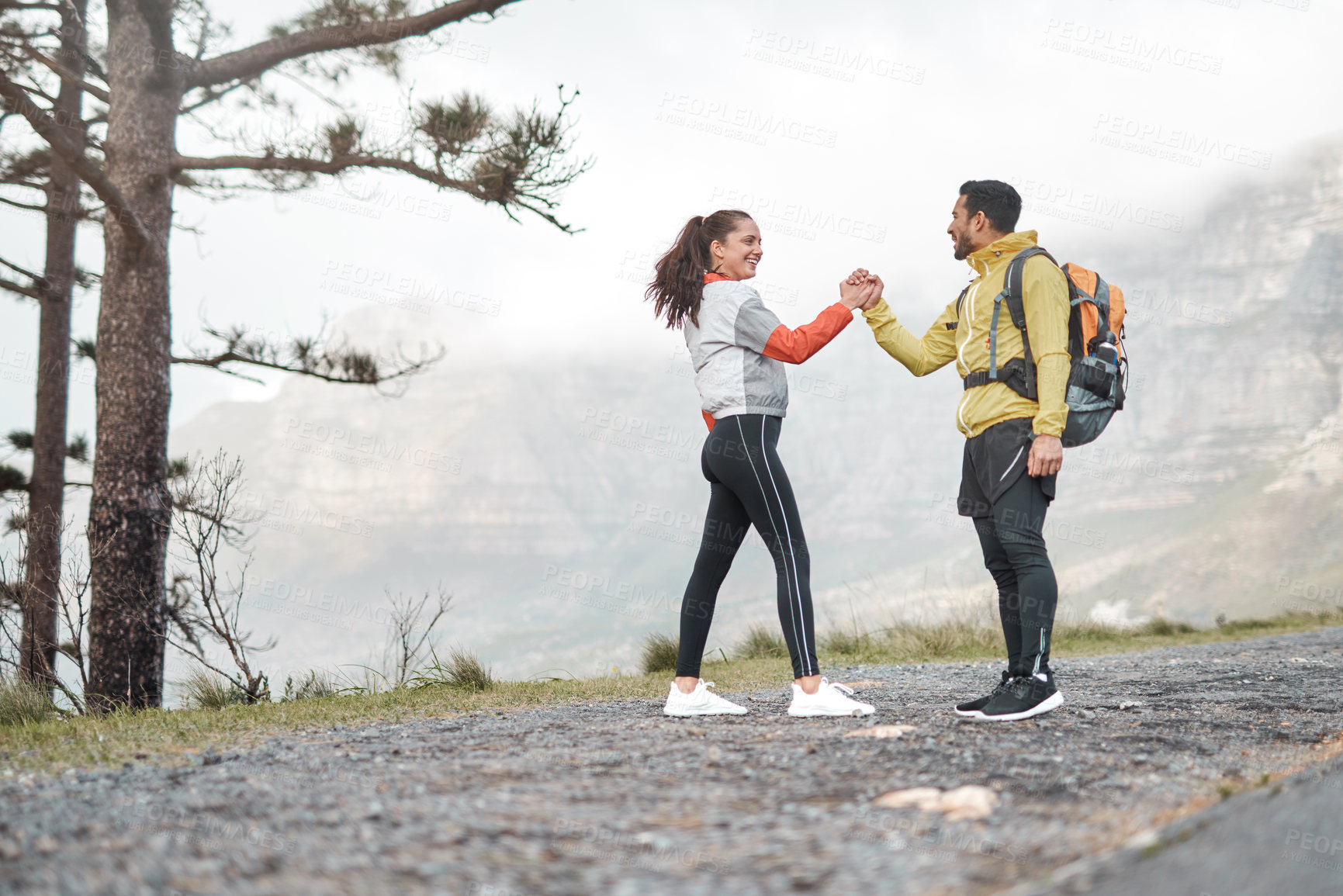 Buy stock photo Full length shot of two young athletes bonding during a hike outdoors